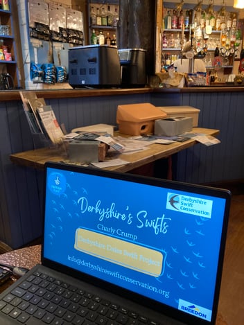 A laptop in front of swift boxes